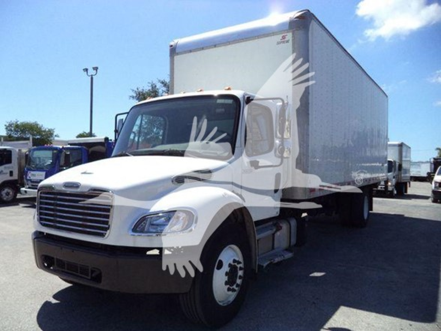 Box truck with a white cab and large box cargo area; Freightliner M2 106 chassis visible from front-left angle.