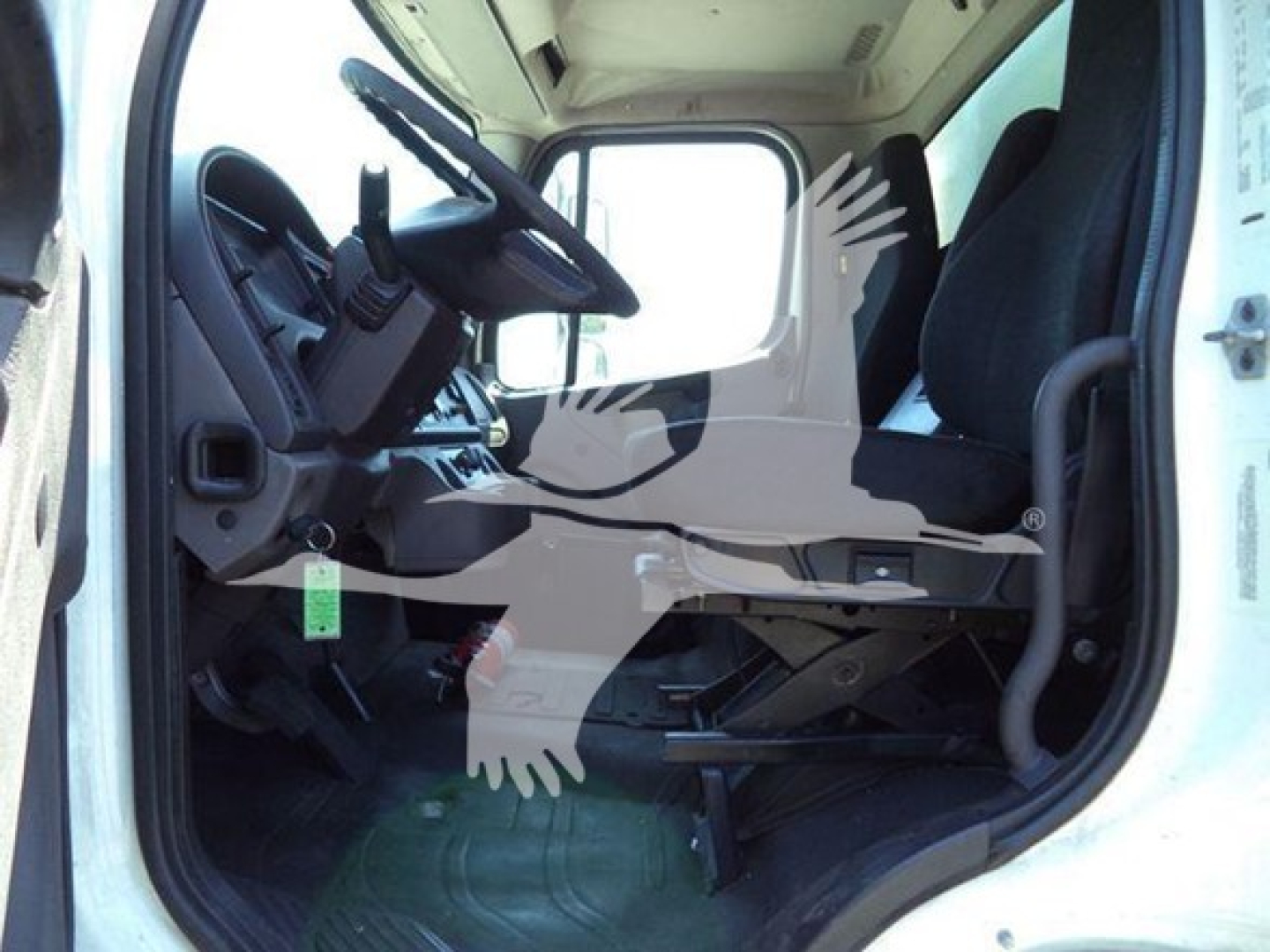 Cab interior of 2018 Freightliner M2 106 truck showing driver seat, steering wheel, and dashboard area