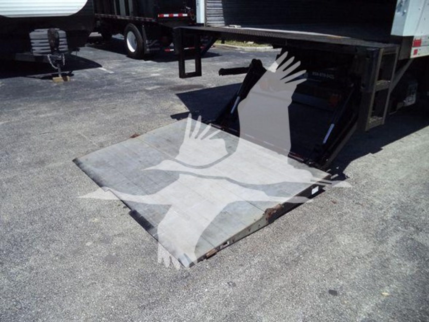 Freightliner M2 106 rear cargo area and auxiliary ramp in loading position showing scale platform with metal surface.