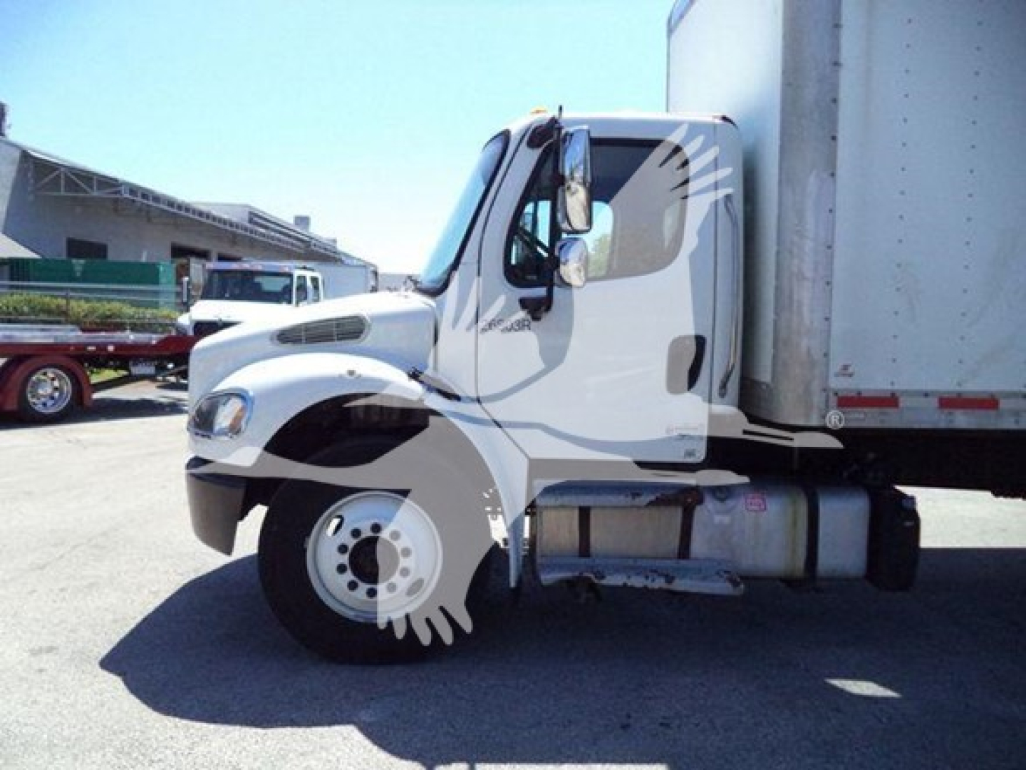 Freightliner M2 106 truck in side view showing cab and front wheel with attached box trailer