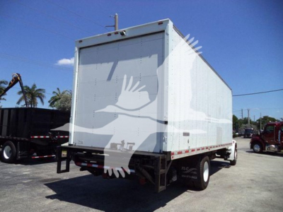 Box truck rear view showing cargo box and dual rear wheels on Freightliner M2 106-style chassis.