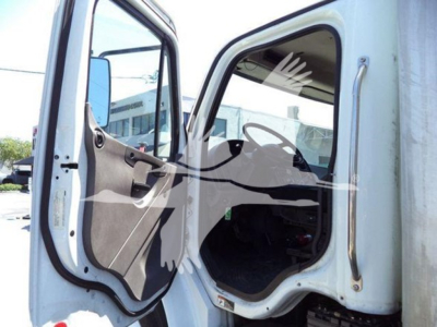 Freightliner M2 106 cabin door area showing open driver door and interior dash components.