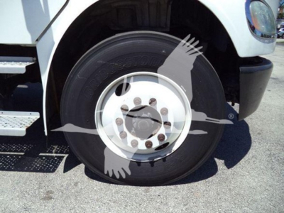 Truck front wheel of a 2018 Freightliner M2 106 showing a white painted rim and Bridgestone tire, part of the box truck chassis.
