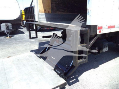 Freightliner M2 106 truck rear with hydraulic liftgate and open side doorway showing loading ramp and platform.