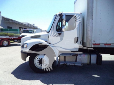 Freightliner M2 106 truck in side view showing cab and front wheel with attached box trailer