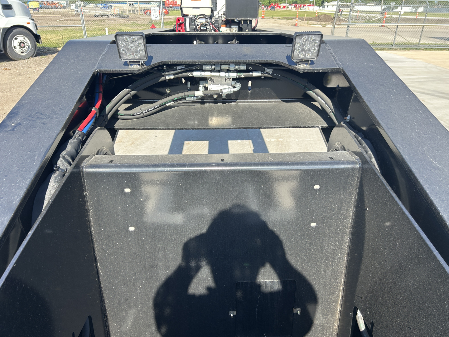 Trailer rear/underframe area showing hydraulic hoses and mounting on a Load King 503/554 SF lowboy trailer bed.