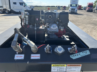 Trailer deck showing a Load King 503/554 SF lowboy with engine and hydraulic components, labels reading RETURN and PRESSURE, warning sticker, and a CAUTION/WARNING plate visible