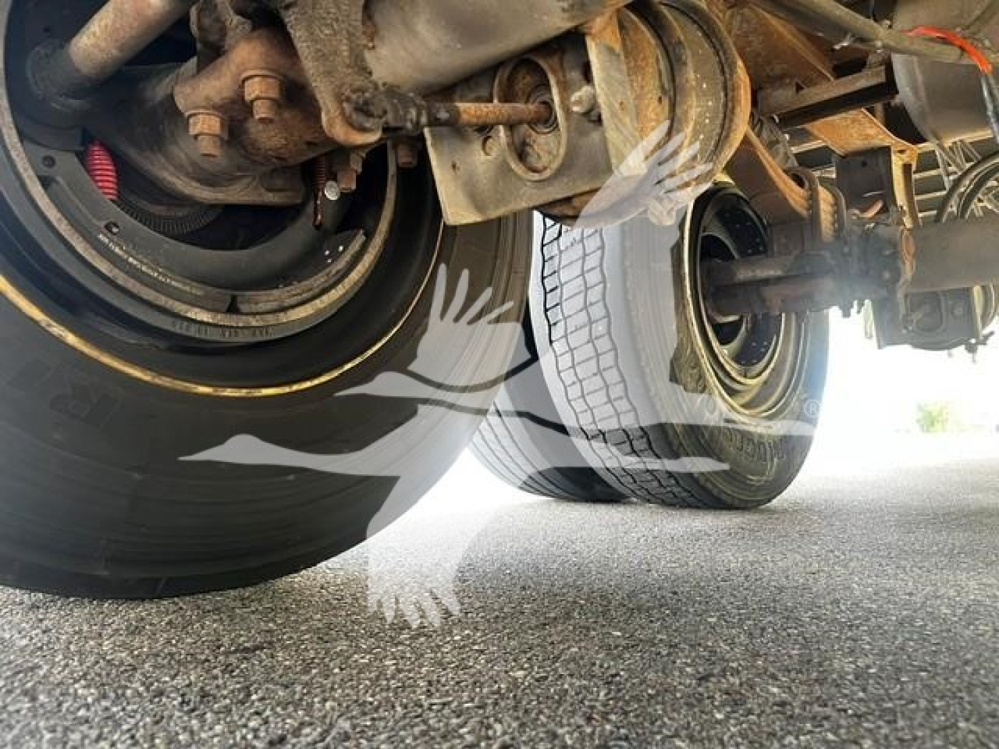 Wabash van trailer underside showing dual axles, tires, and suspension components.