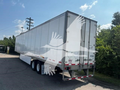 Trailer side and rear showing 2017 Wabash van trailer with triple axle and white body.