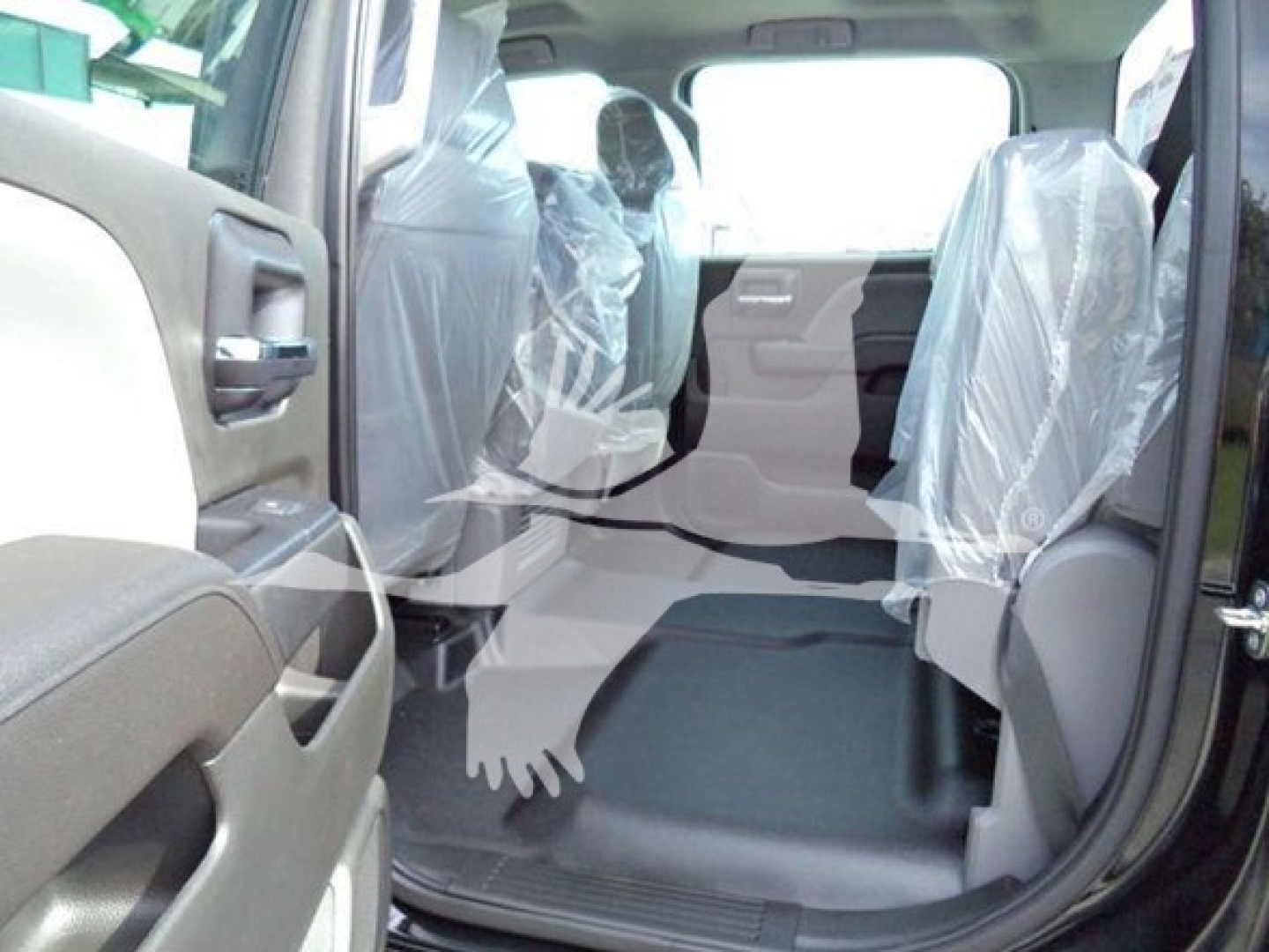 Interior of a 2023 International CV truck with plastic seat covers visible in the rear and front seating area.