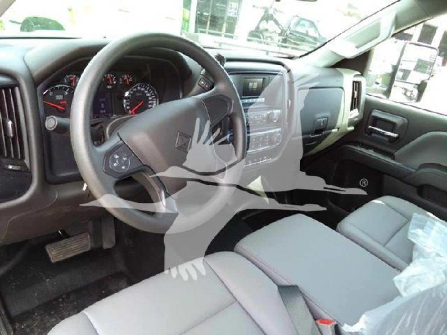 Truck interior showing steering wheel, dashboard, and center console of a 2023 International CV in a new condition.