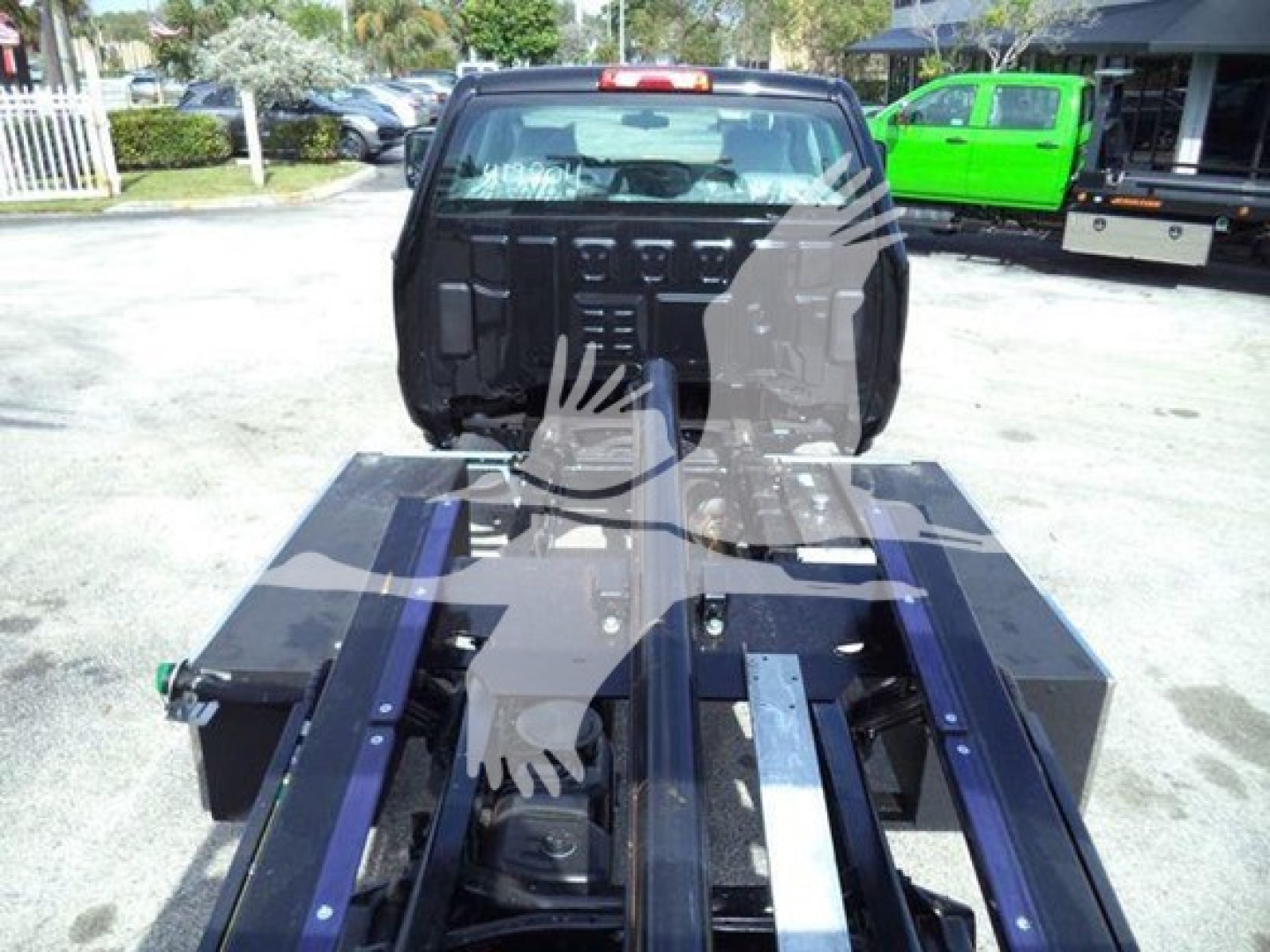 Truck cab with a heavy-duty rollback chassis showing frame rails and mounting points for a CV International truck.