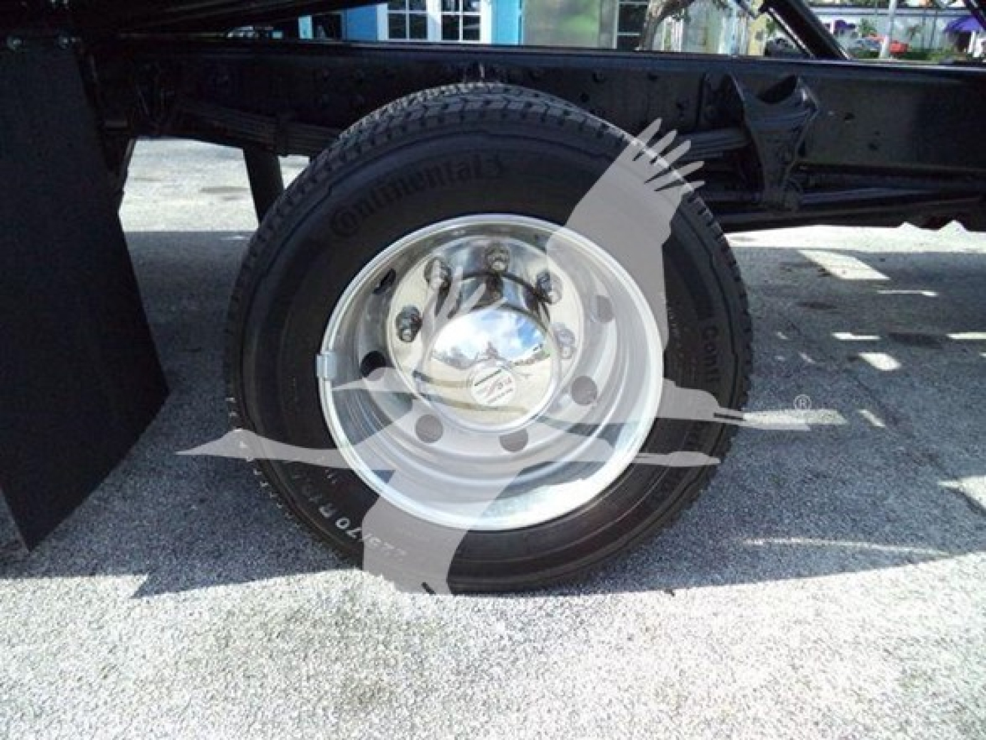 Truck wheel and tire showing Continental tire on a steel rim with polished hubcap.