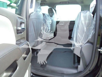 Interior of a 2023 International CV truck with plastic seat covers visible in the rear and front seating area.