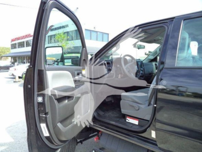 Truck cab interior with open front door showing steering wheel and dashboard of a 2023 International CV rollback truck.