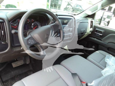 Truck interior showing steering wheel, dashboard, and center console of a 2023 International CV in a new condition.