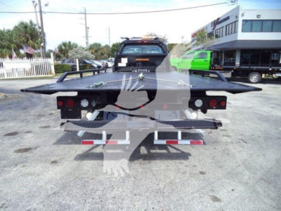 Rear view of a tow truck chassis/rollback with flatbed and taillights visible