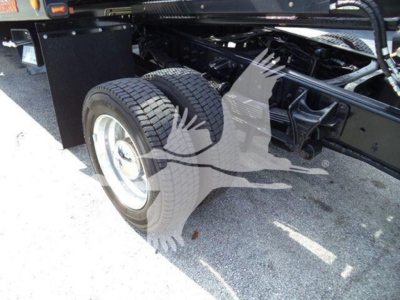 Truck chassis with dual rear wheels showing suspension and frame along with wheel and tire details.