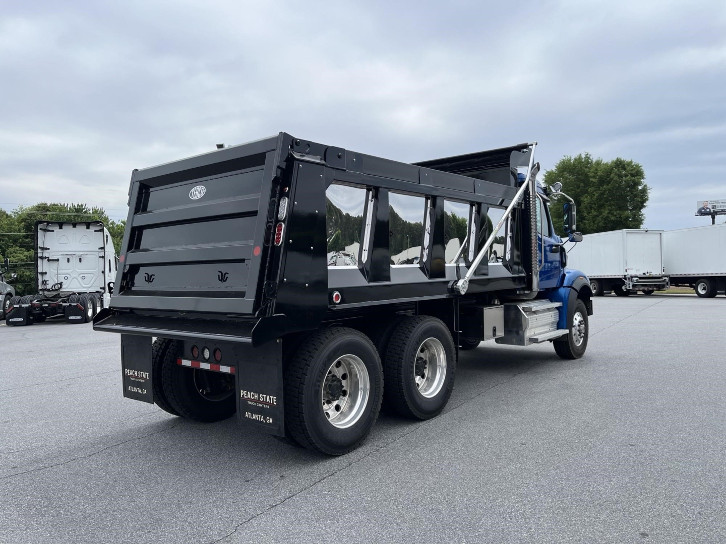 Truck dump body showing 2027 Western Star 47X with black dump bed and dual rear axles.