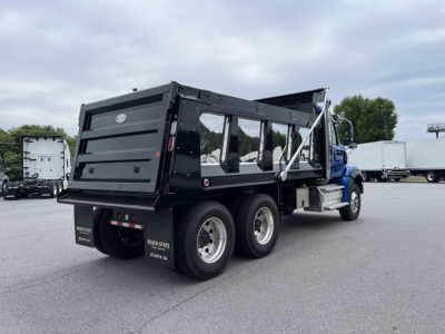 Truck dump body showing 2027 Western Star 47X with black dump bed and dual rear axles.