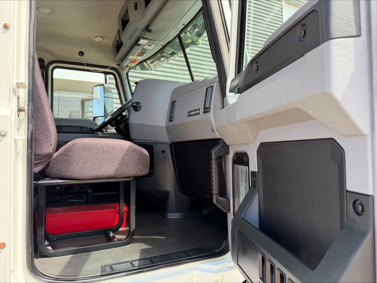 Cab interior of a 2020 Mack Anthem daycab showing driver seat, dashboard, and entry area.