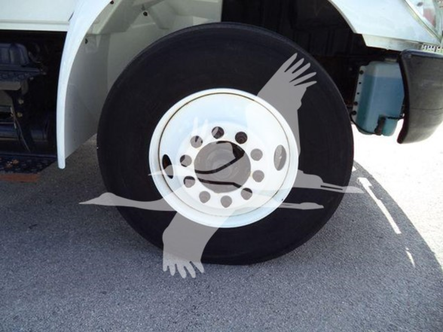 Wheel and front fender view of a 2019 International Durastar 4300 dump truck showing front tire and wheel assembly.