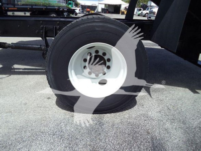 Wheel and tire assembly of a 2019 International Durastar 4300 dump truck showing white steel wheel and hub area