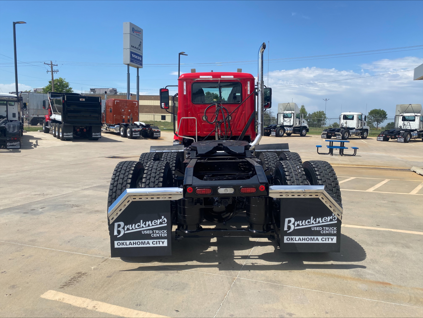 Truck chassis rear view showing dual rear axles and mud flaps with Bruckner’s Used Truck Center Oklahoma City branding.