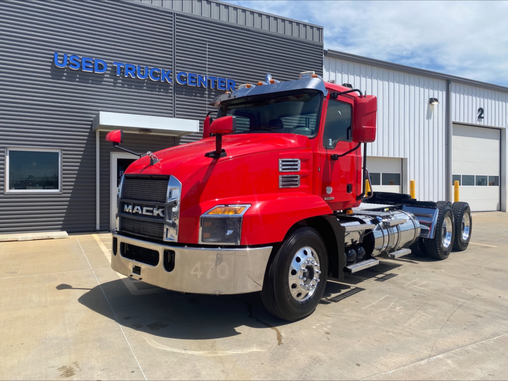Mack Anthem daycab truck in red exterior viewed at front three-quarter angle showing front grille and cab with chrome bumper.