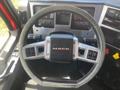 Mack steering wheel in cab showing dashboard and controls in Mack Anthem truck interior.