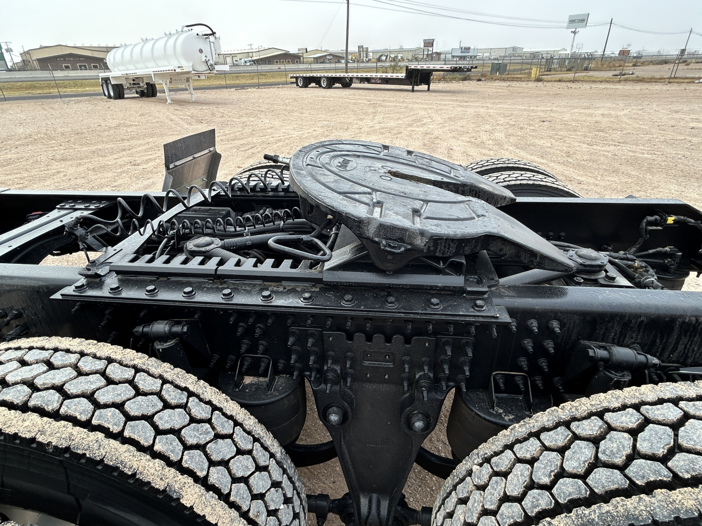 Mack PR64T44 truck chassis showing drivetrain accessible from cabless area, with fifth wheel and twin axles near the frame.