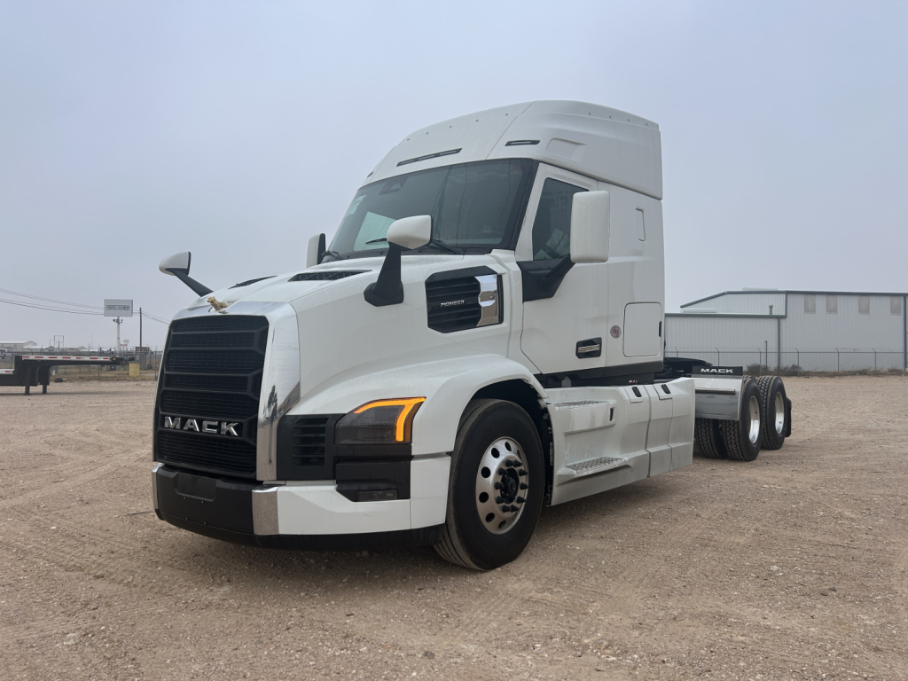 Mack PR64T44 conventional sleeper truck angled view showing front grille, headlights, and side mirrors.
