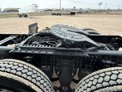 Mack PR64T44 truck chassis showing drivetrain accessible from cabless area, with fifth wheel and twin axles near the frame.