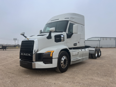 Mack PR64T44 conventional sleeper truck angled view showing front grille, headlights, and side mirrors.
