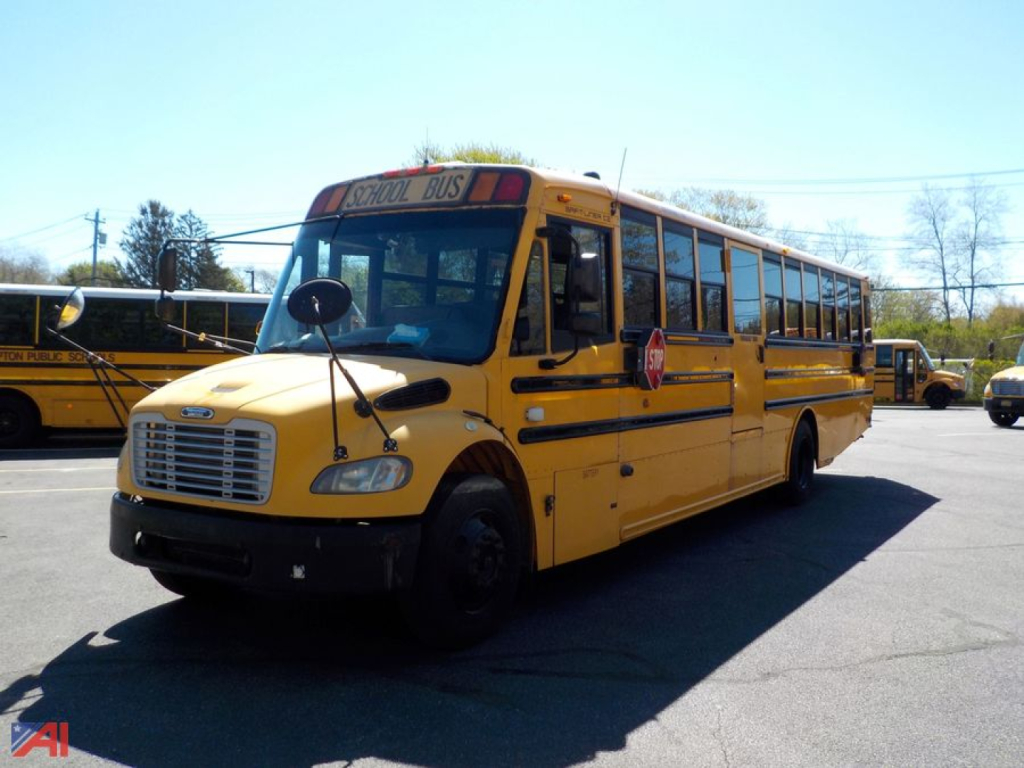 Yellow freightliner school bus side view showing front grille and stop sign, B2 model used in-service
