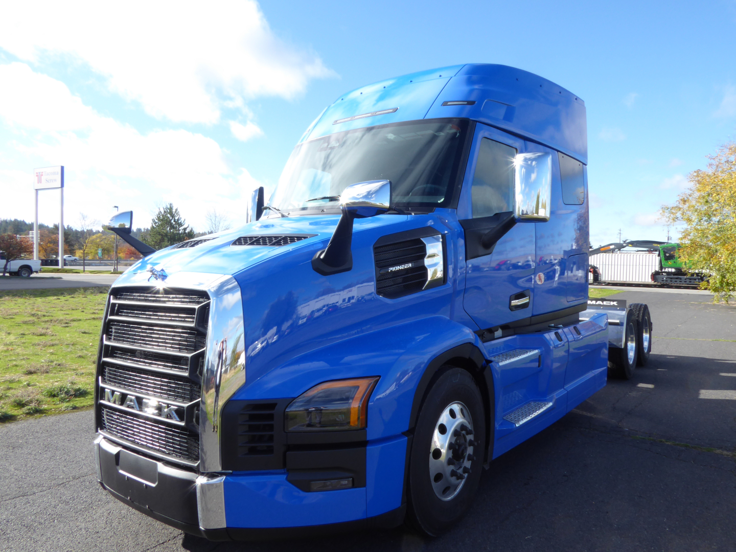 Blue 2026 Mack PR64T64 tractor-trailer truck shown from front-left; visible text includes MACK on grille, no other legible labels.