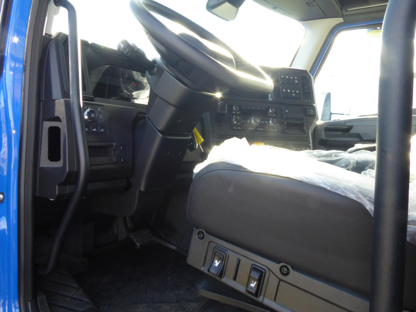 Cab interior of a 2026 Mack PR64T64 truck showing steering wheel dashboard and driver seat.