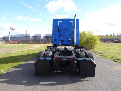 Mack PR64T64 tractor rear view showing fifth wheel and dual rear axles with blue sleeper cab.