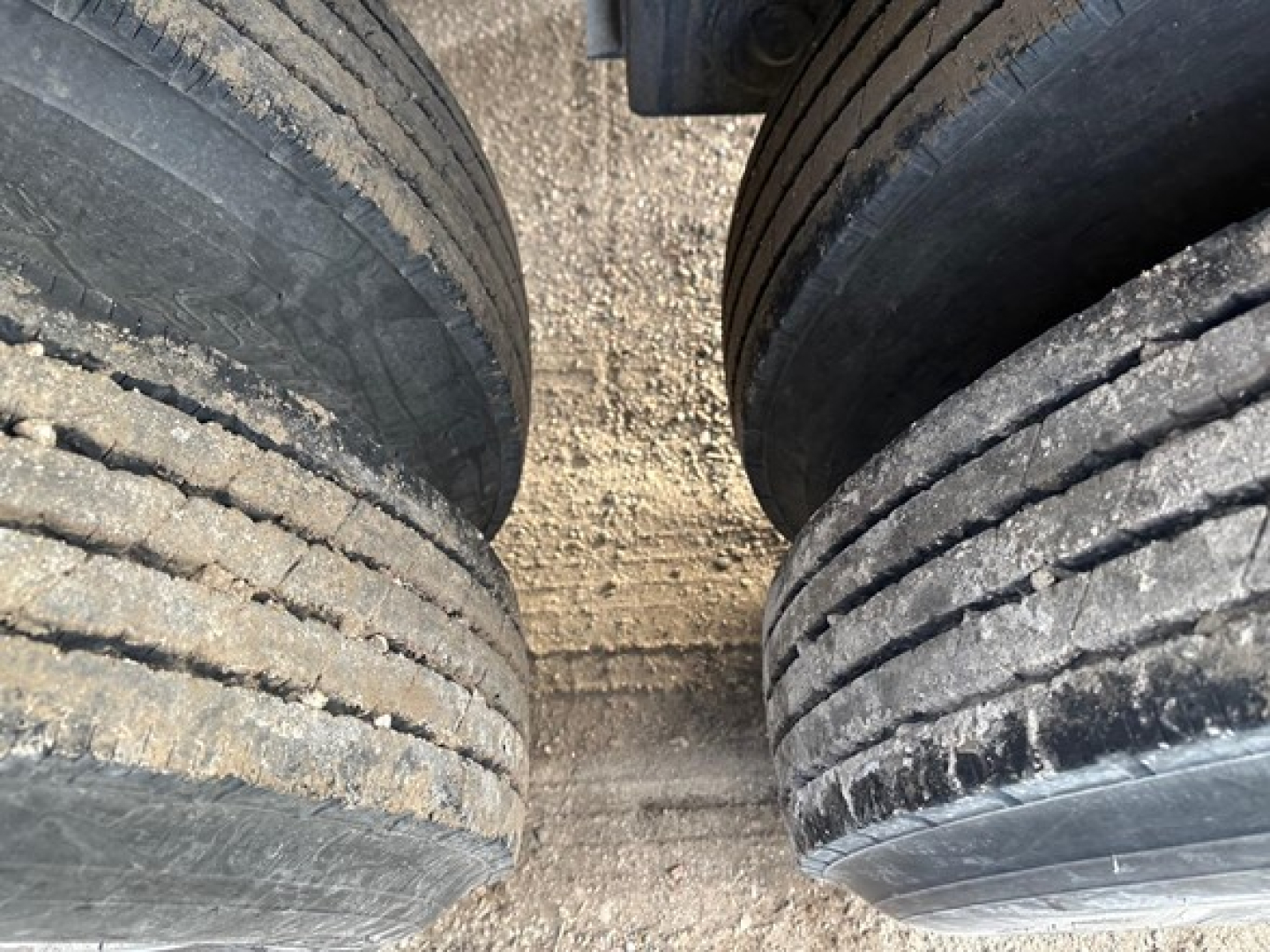 Dual trailer tires close-up on a 40' air ride bottom dump trailer showing tread and sidewalls.