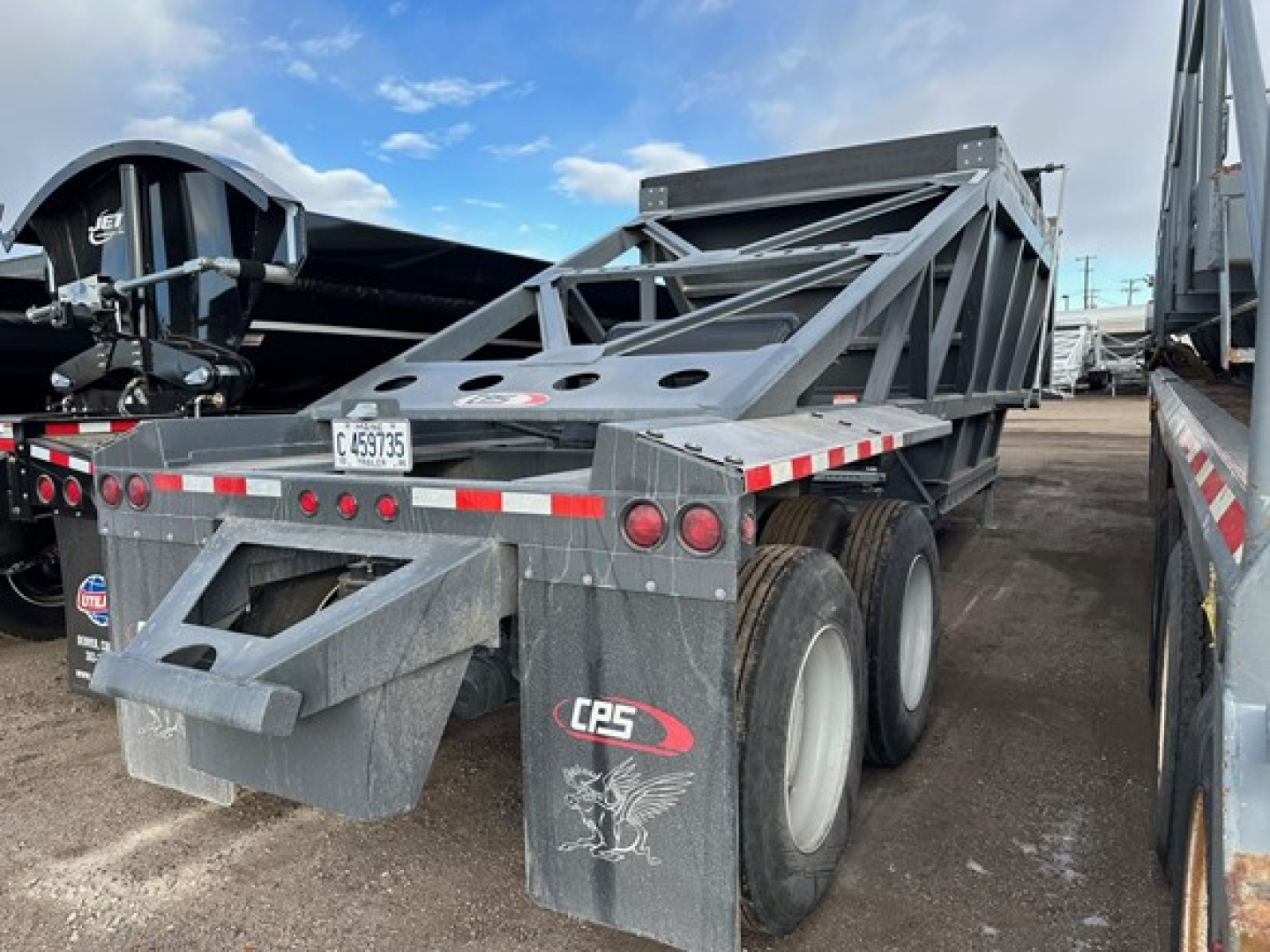 CPS 40' air ride bottom dump trailer showing dual rear axles and gray structural frame with CPS logo on mud flaps.