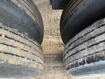 Dual trailer tires close-up on a 40' air ride bottom dump trailer showing tread and sidewalls.