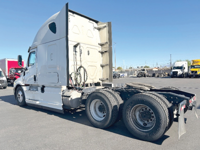 Truck cab and chassis of a 2020 Freightliner Cascadia126 sleeper tractor showing rear view with twin rear axles and fifth wheel area