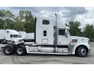 Freightliner Coronado sleeper cab tractor shown in side profile with chrome fuel tanks and twin rear axles. visible text includes no legible labels on tanks from distance.
