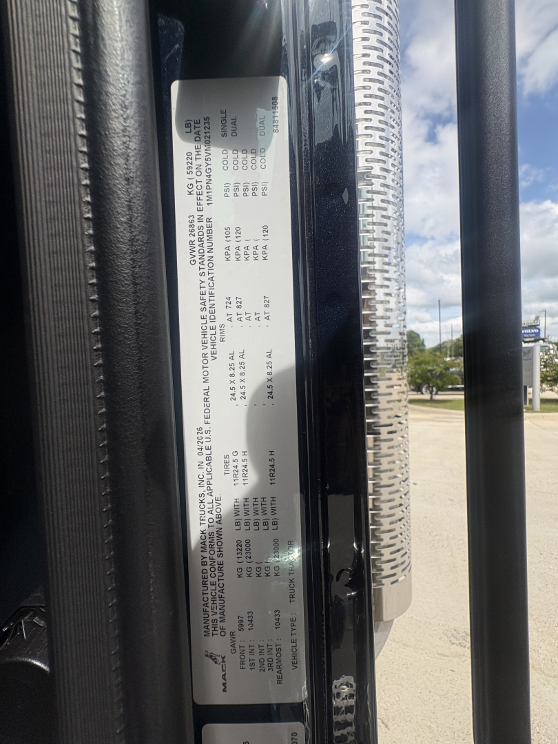 Vehicle info label on Mack PI64T showing technical specs and tire/wheel data.