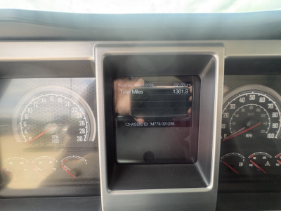 Truck instrument cluster with central digital display showing total miles 1361.9 and chassis ID M78 01236 in-view. Left and right analog gauges visible.
