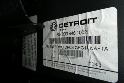 Truck part label on Detroit emission sticker with DETROIT logo and barcode showing serial numbers and electrical CPC4 GHG14 NAFTA details.