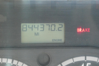 Truck instrument cluster displaying mileage 844370.2 MI, BRAKE indicator, ENGINE text, and partial gauges.