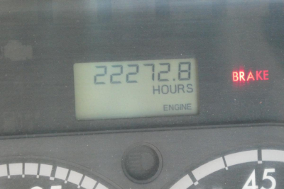 Truck dashboard showing hour meter reading 22272.8 hours and brake warning light illuminated.