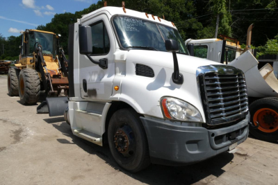 Truck image showing a white Freightliner Cascadia 113 daycab with front grille, headlights, and side mirrors. Visible text includes: windshield glare, no legible small print.