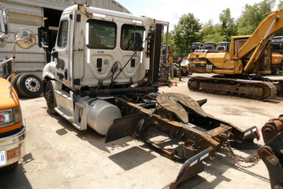 Truck tractor cab in-service showing front and trailer hitch with attached kingpin and swing away FW mount.